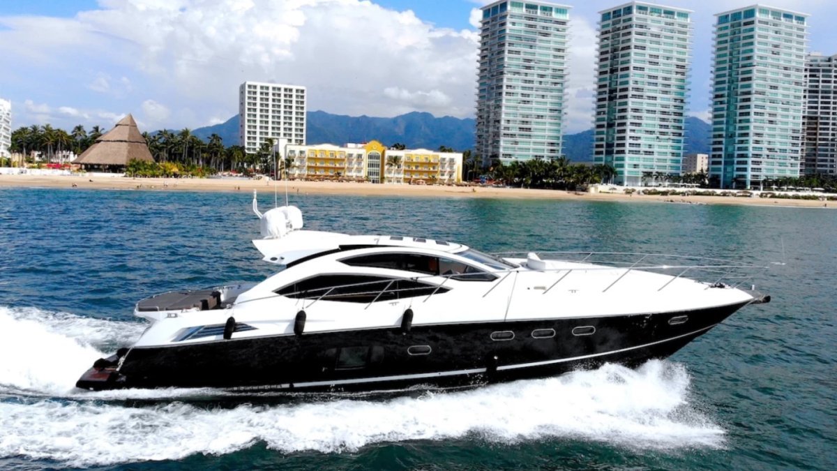 Sunseeker 64 private yacht cruising in front of the Puerto Vallarta hotel zone, available as a yacht charter by owner